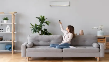 Woman sitting on couch checking temperature