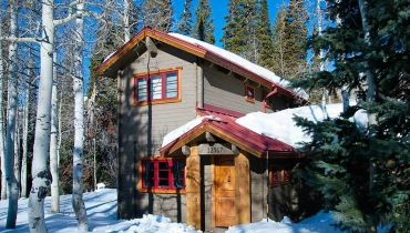 Winter cabin covered with snow
