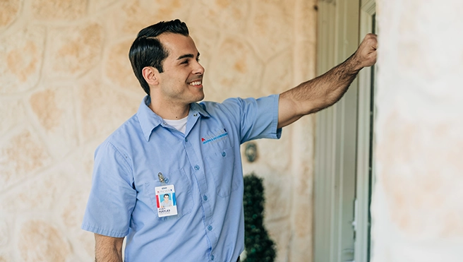 An Aire Serv Technician knocking on a customer's door.