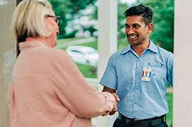 Aire Serv technician shakes hands with a customer.