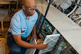 Aire Serv technician installing air filters.
