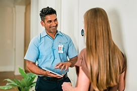 An Aire Serv technician talking to a customer.