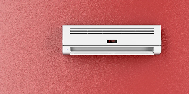 Ductless split unit mounted on red wall
