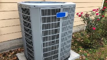 New air conditioning unit outside residential home.