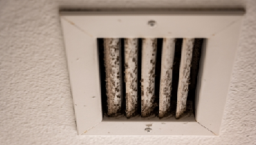 White HVAC vent showing dirt and mould growth from daily use
