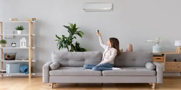 Woman sitting on couch checking temperature