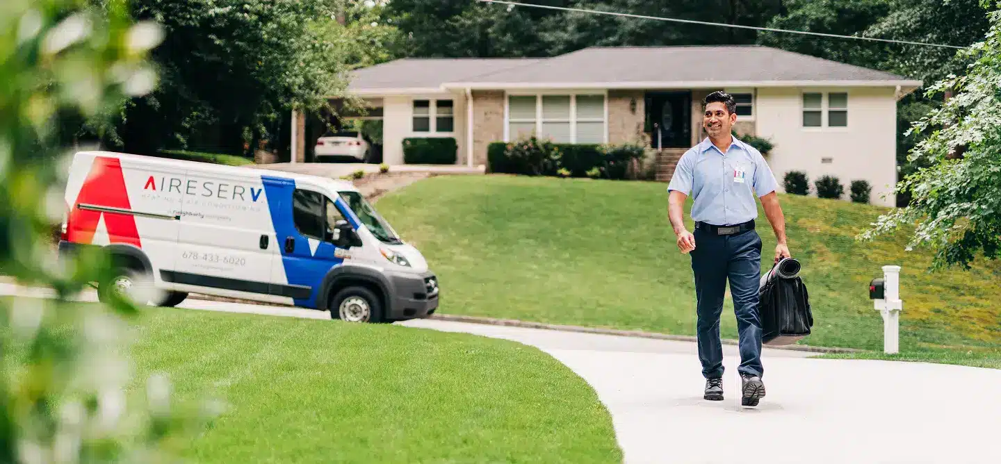 Trusted furnace repair professional in front of van.