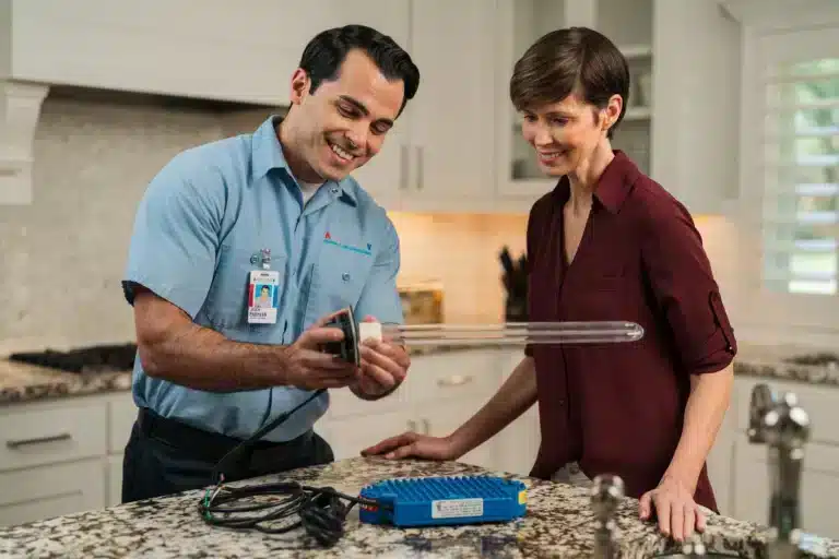 Trusted furnace repair professional talking with home owner.